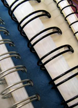 zoomed in view of the spines on several wire spined books